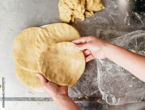 Top view of a woman's hands making arepas