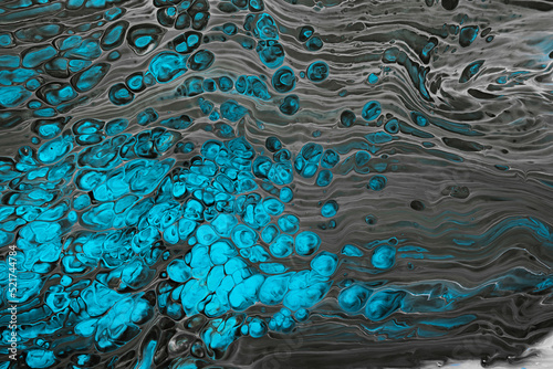 Fluid Art. Abstract mixing black waves and turquoise bubbles. Liquid flows splashes. Marble effect background or texture