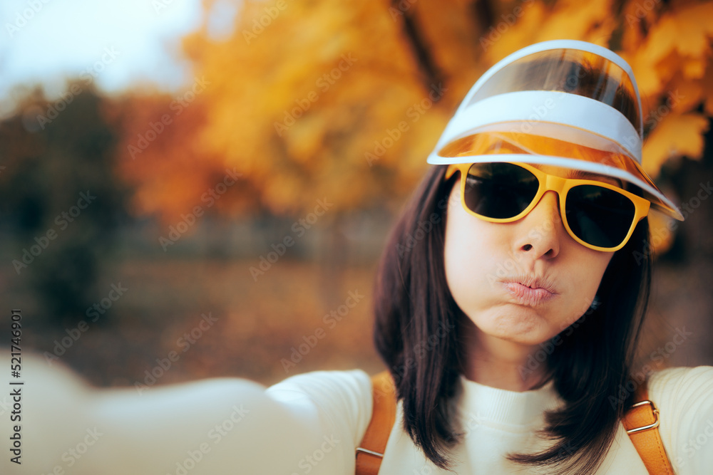 Funny Woman Wearing Sunglasses and Visor Taking a Selfie Outdoors. Awkward girl filming and taking pictures on a trip
Funny Woman Wearing Sunglasses and Visor Taking a Selfie Outdoors. Awkward girl filming and taking pictures on a trip