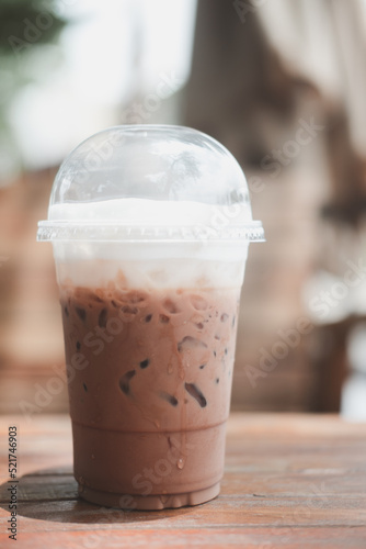 Iced Mocha coffee in take home plasttic cup on table.