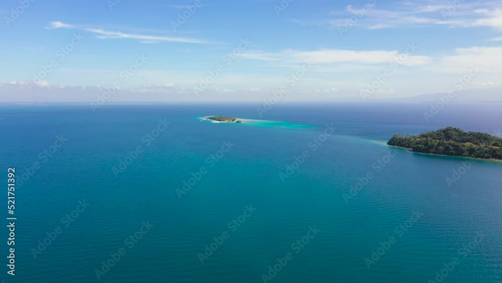 Aerial view of Big Liguid Island with sand beach, palm trees by atoll with coral reef. Big Cruz Island, Philippines, Samal. Aerial view of Big Liguid Island with sand beach, palm trees by atoll with coral reef. Big Cruz Island, Philippines, Samal.