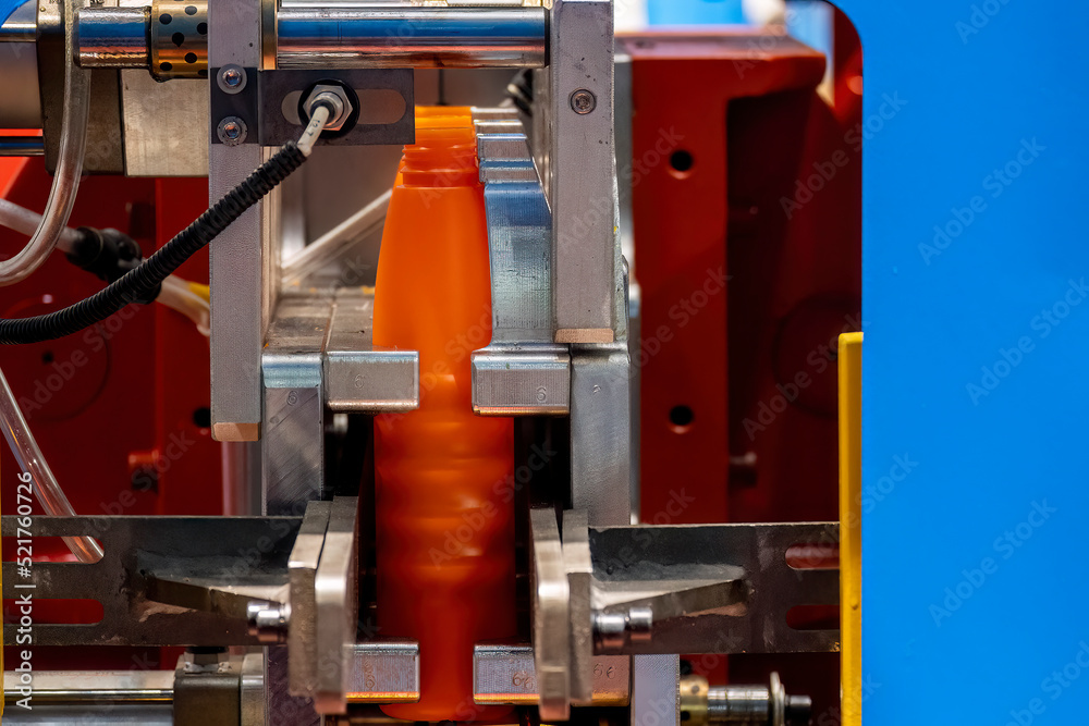 The orange bottle container manufacturing process by blow mold machine.