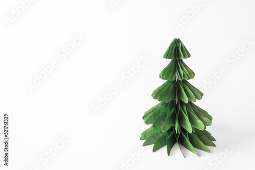 Handmade foldable Christmas tree from plastic free material - green paper isolated on white background. DIY concept.
