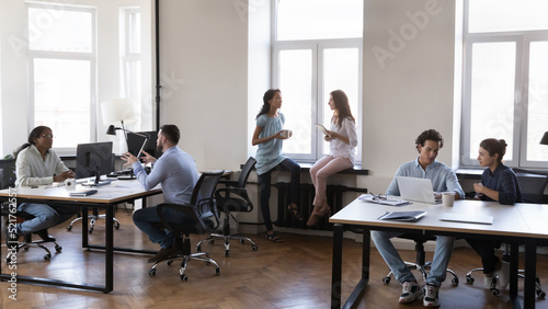 Group of busy department staff members, multi ethnic diverse company employees working gathered together in coworking room. Office rush, workflow use modern tech, communication, human resource concept