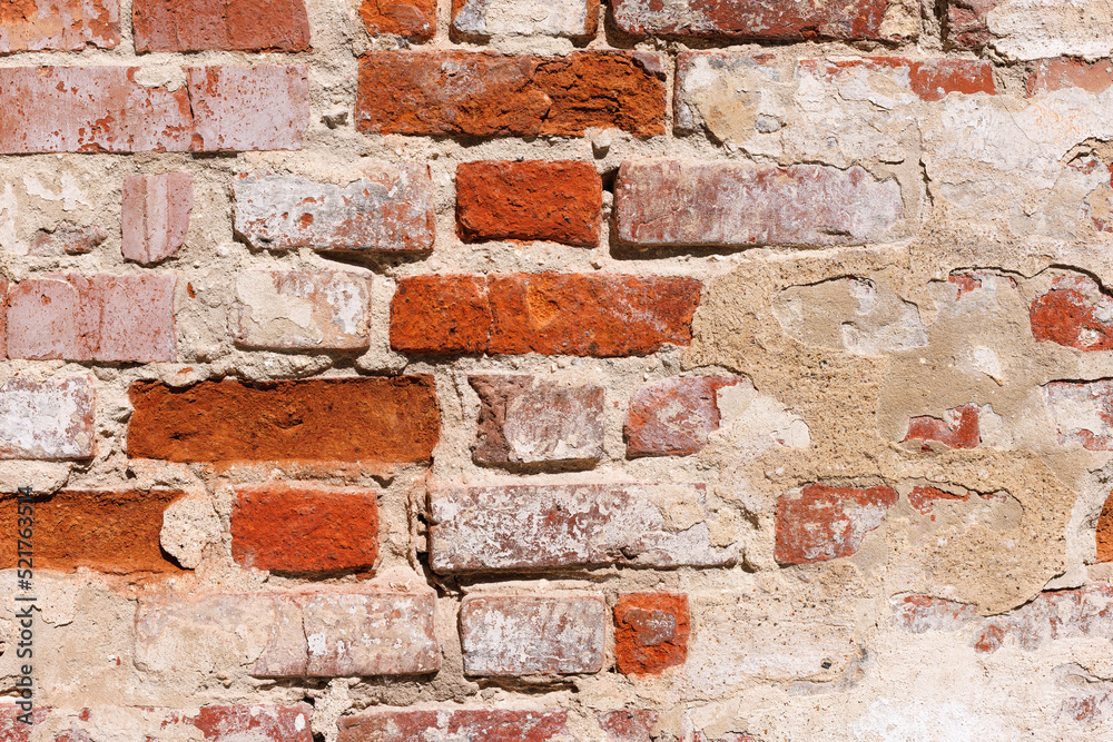 Old red brick wall with remains of lime plaster. Old red brick wall with remains of lime plaster.