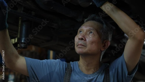 Wallpaper Mural mechanic technician work to fixing repair car undercarriage at auto garage, vehicle inspection station for automobile maintenance service workshop, person using automotive industry tool for work Torontodigital.ca