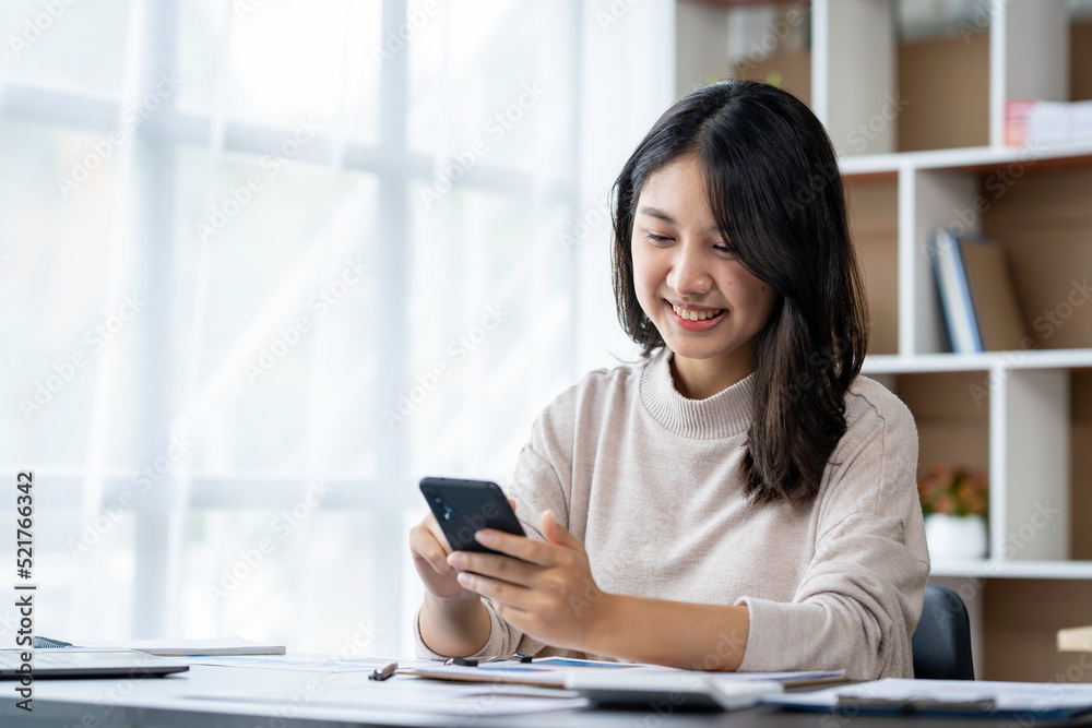 Asian businesswomen use laptops and smartphones in an open space office. Business concept. Data analysis, roadmap, marketing, accounting, auditing. Asian businesswomen use laptops and smartphones in an open space office. Business concept. Data analysis, roadmap, marketing, accounting, auditing.