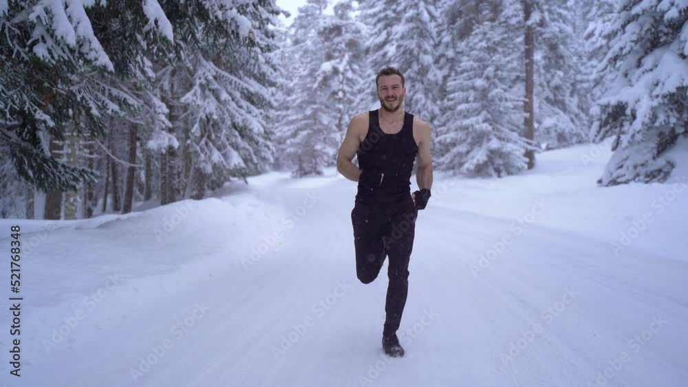 Man running on snowy road.
Sportsman running in winter forest in snowy weather. Pine trees covered with snow.
Man running on snowy road.
Sportsman running in winter forest in snowy weather. Pine trees covered with snow.