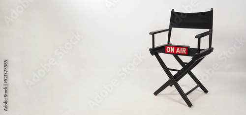 Black director chair and on air box on the chair on white background. studio shot