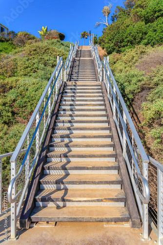 Fototapeta Naklejka Na Ścianę i Meble -  Outdoor stairs with wooden steps and metal railings at San Clemente, California