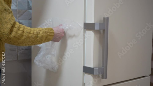 refrigerator unpacking,purchase of household appliances for the kitchen, a new refrigerator is unpacked by a man