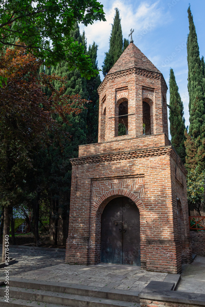 The ancient brick bell tower of St. George Kari in the historical part of the city of Tbilisi. Georgia
