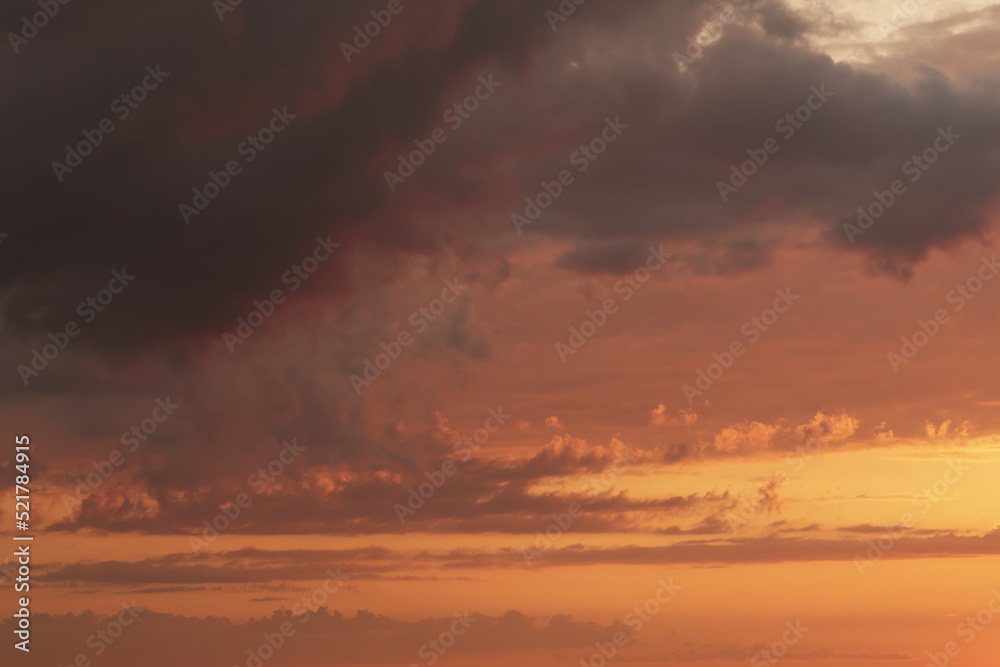 Soft clouds with orange light during summer sunset