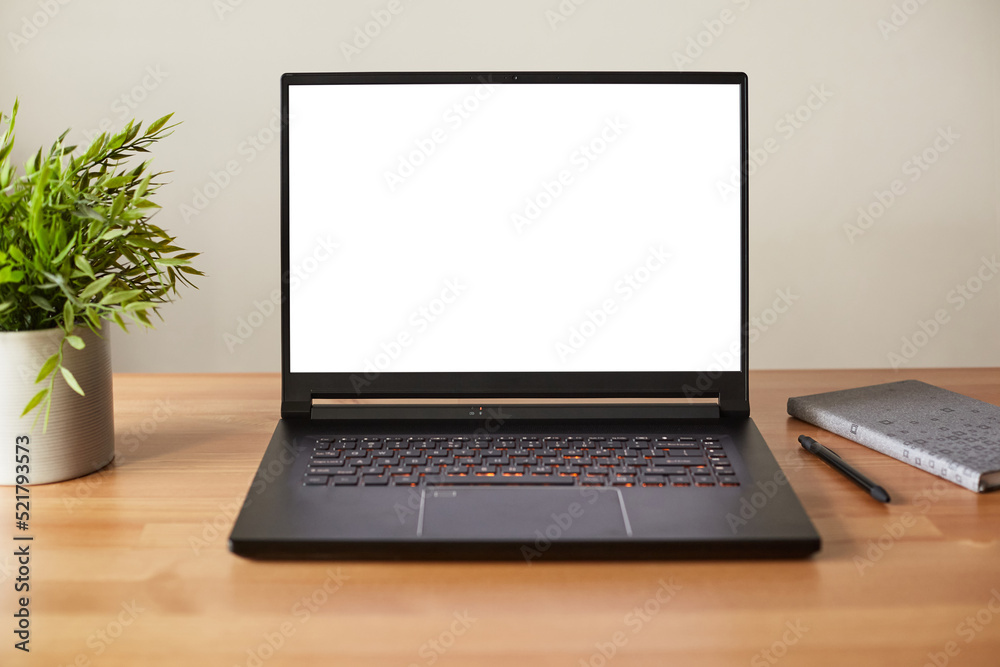 Laptop with blank screen on work wooden table. Laptop with blank screen on work wooden table.