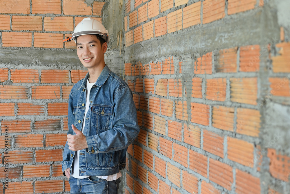 Portrait of Young male construction engineer or Architect with a blueprints at a construction site, look in camera. Portrait of Young male construction engineer or Architect with a blueprints at a construction site, look in camera.