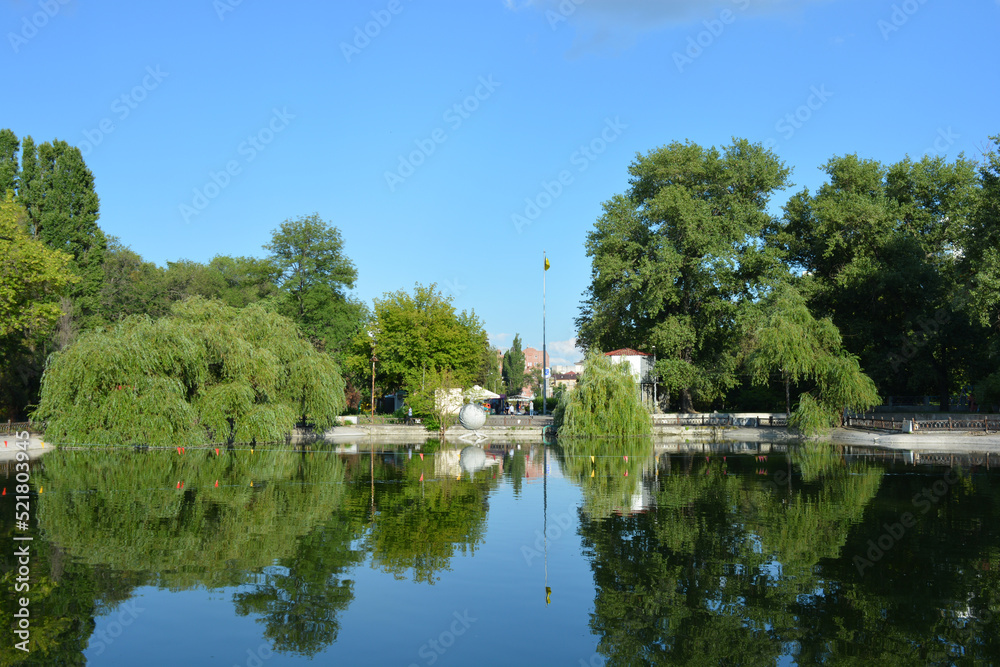 The park has lake, water theatre, bridge, trees, park areas, shops, monuments, protected areas is Lazar Globa Park. Houses, buildings and sights of the city of Dnipro, Ukraine.