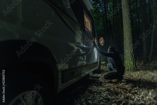 Robber Trying to Break the Lock of the Motorhome Vehicle