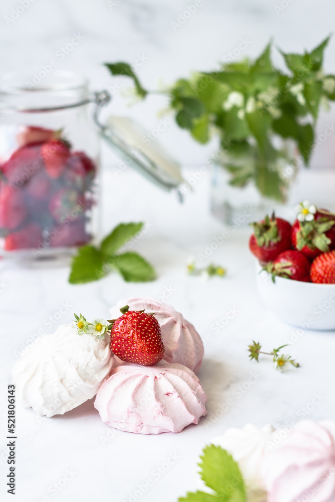 Red and white marshmallows and strawberries on a white background Red and white marshmallows and strawberries on a white background