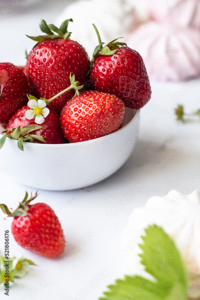 Ripe strawberries close-up in a white cup on a white background Ripe strawberries close-up in a white cup on a white background