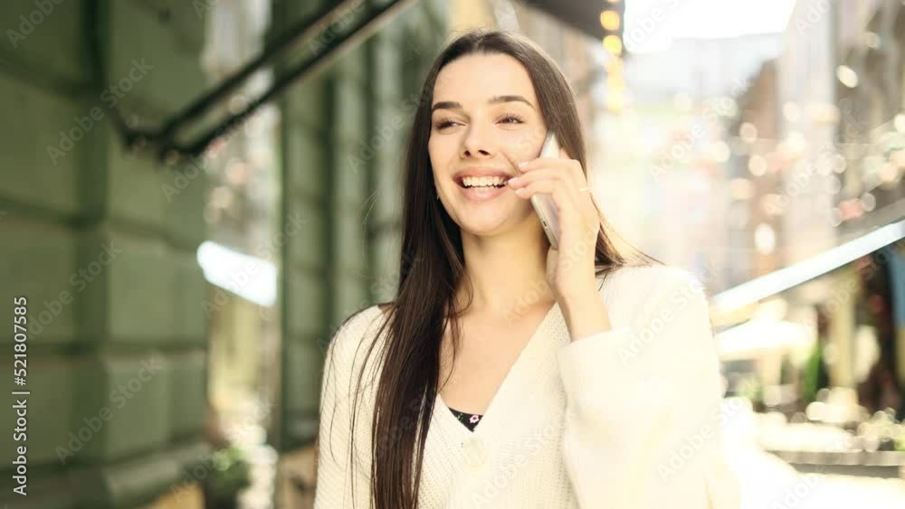 Portrait of attractive girl having phone talk. Young beautiful girl at the city street. Portrait of attractive girl having phone talk. Young beautiful girl at the city street.