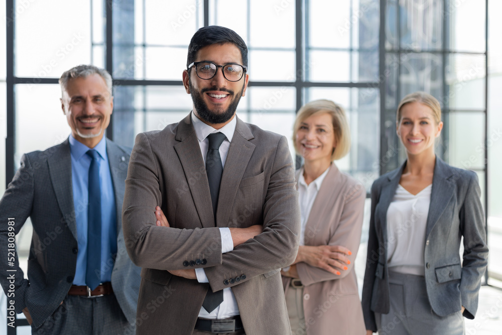 Businessman with colleagues in the background in office. Businessman with colleagues in the background in office.