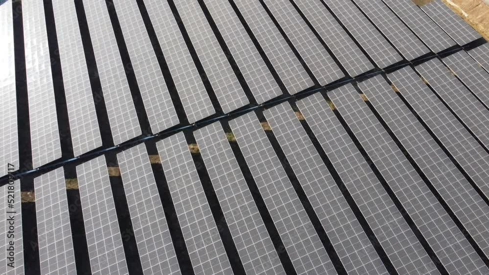 4K fly over the Solar cell panel from an aerial view. Photo landscape of a solar farm producing clean energy.