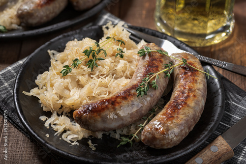 Tableau sur toile Grilled bratwurst and sauerkraut meal