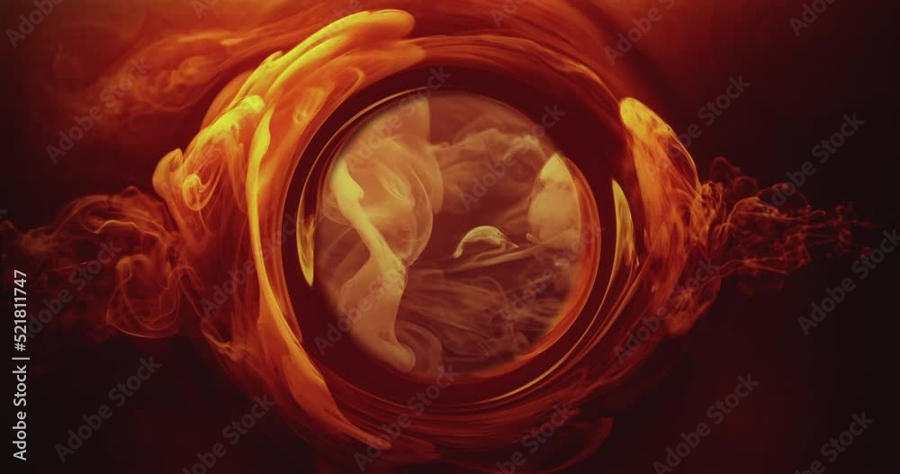 Smoke round frame. Ink water flow. Occult wheel. Hot blast. Orange yellow color fume cloud glow in circle whirl on dark black abstract background shot on RED Cinema camera.