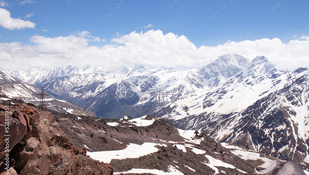 Panorama of a colored mountain landscape with the snow covered mountains