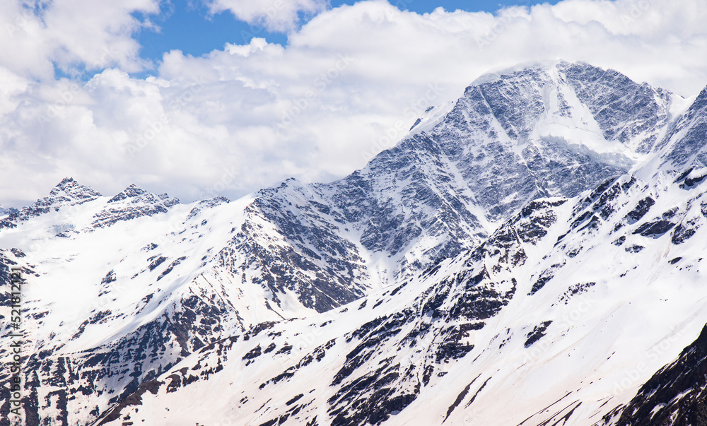 Panorama of a colored mountain landscape with the snow covered mountains