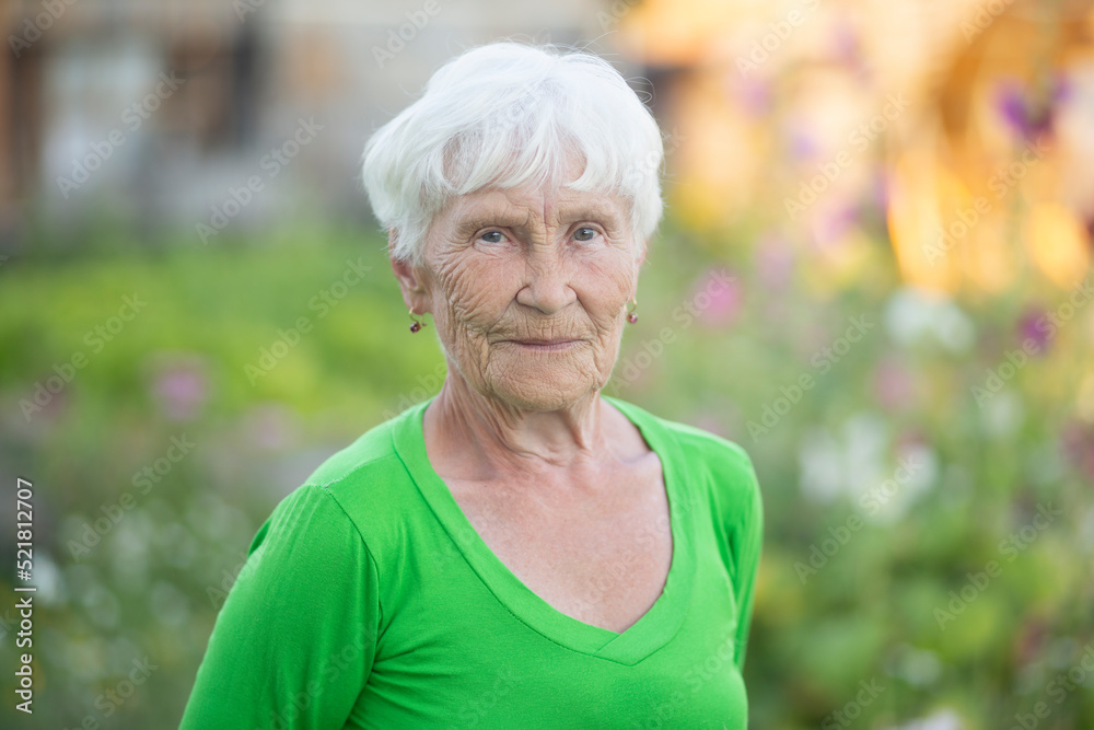 Portrait of an elderly woman on the street.The pensioner is at home. Portrait of an elderly woman on the street.The pensioner is at home.