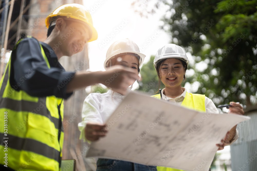 Construction engineers discussion with architects at construction or building site