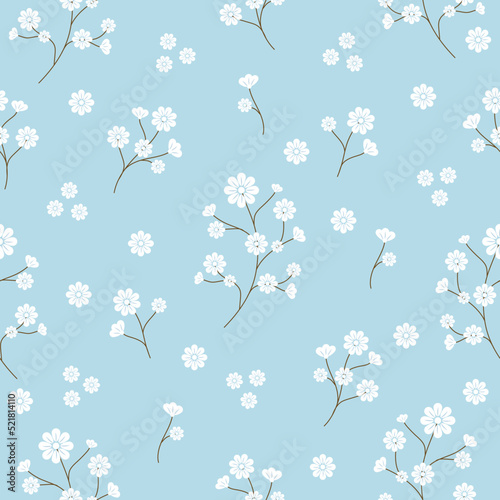 Seamless pattern with white flowers is tiny elegant flowers and stems  on blue background. Botanical hand drawing pattern. Texture for fabric, textile, gift wrapping, card, and wallpaper.