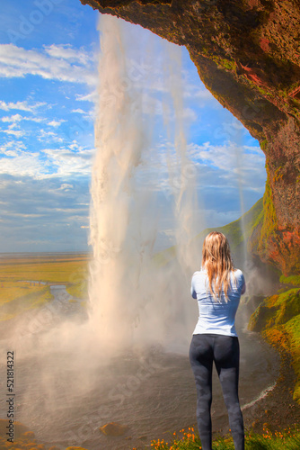 Beautiful girl take a selfie - Icelandic Landscape concept - View of famous Amazing Seljalandsfoss waterfall in Iceland