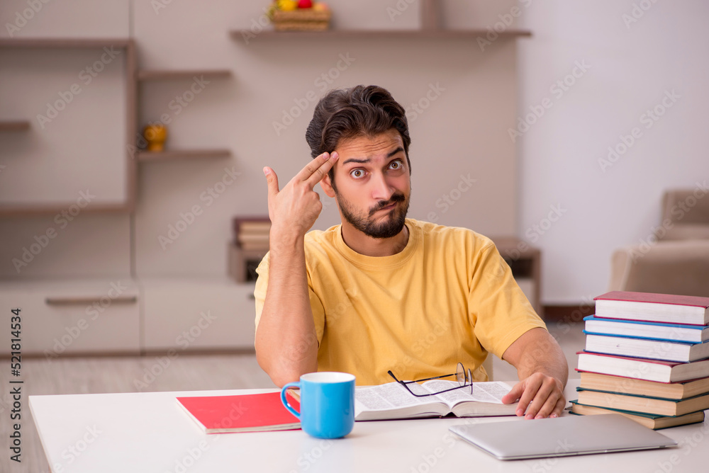 Young male student preparing for exams at home Young male student preparing for exams at home
