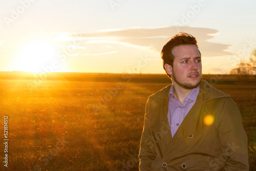  Young man in the field with sunset sun  © Siur