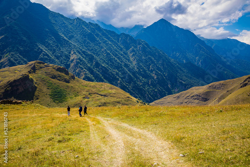 Men walk along the road high in the mountains, the village of Galiat, North Ossetia.