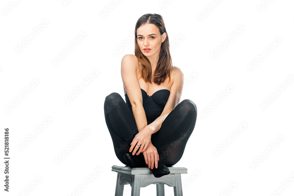 Lifestyle attractive woman posing on white isolated background. Young pretty model sitting on the chair. Lifestyle attractive woman posing on white isolated background. Young pretty model sitting on the chair.