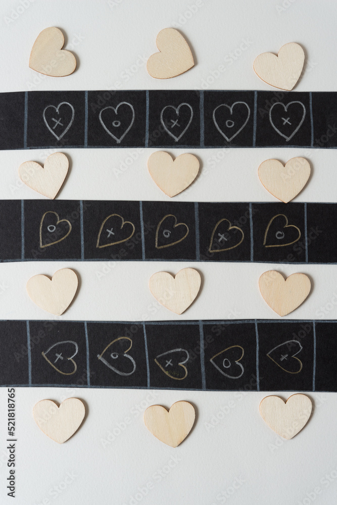 set of freehand and wooden hearts on paper