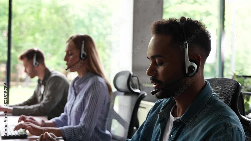 Male representative call center agent in wireless headset helping client, operator working in customer support service