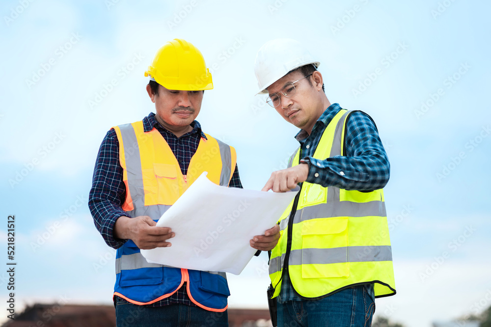 Engineer and Foreman construction site holding blueprint. Engineer and Foreman construction site holding blueprint.