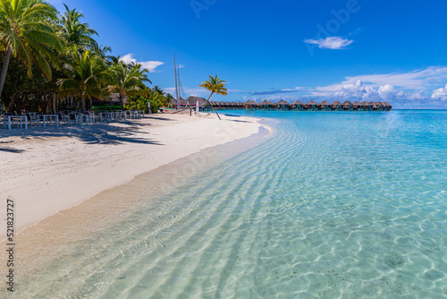 Fototapeta Naklejka Na Ścianę i Meble -  Beautiful beach with white sand, turquoise ocean lagoon, green palm trees and blue sky with clouds on sunny day. Summer tropical landscape, panoramic view. Tropical beach in the Maldives vacation