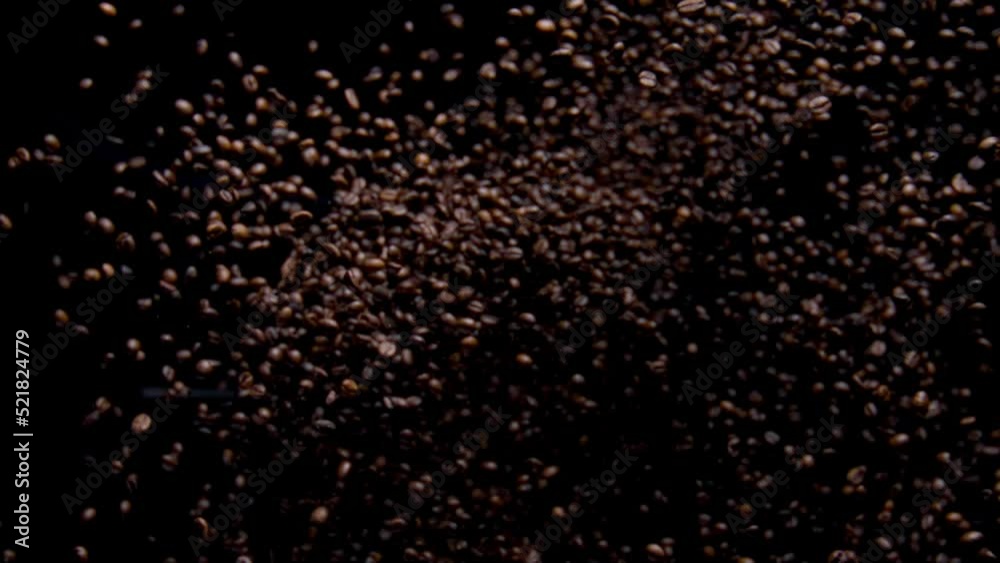 Super slow motion coffee grains exploding. Closeup aromatic seeds falling down. Super slow motion coffee grains exploding. Closeup aromatic seeds falling down.