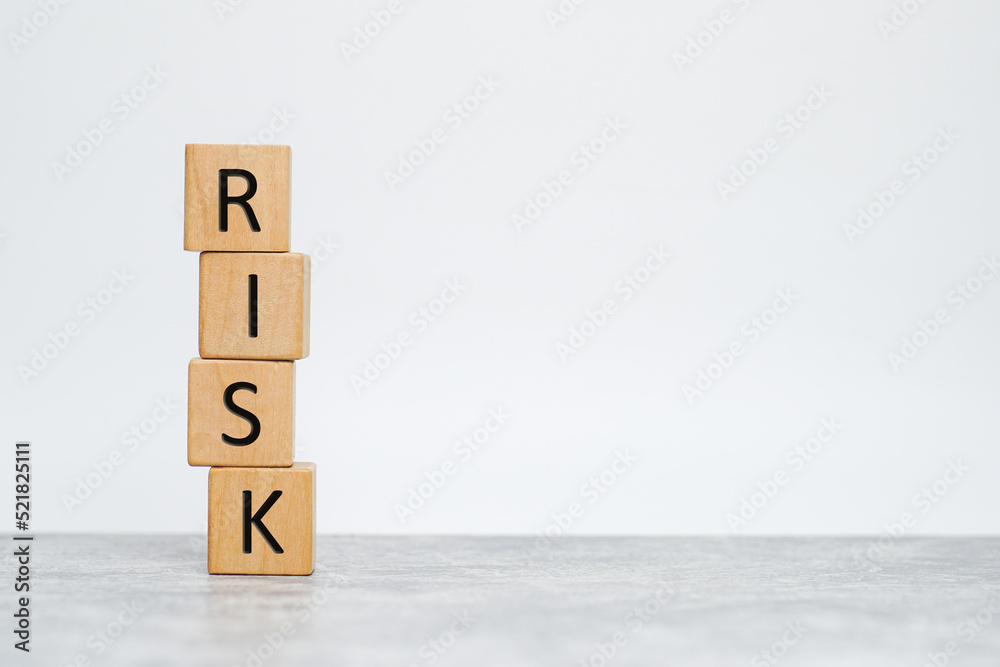 Wooden cubes with the word risk. Risk taking, risk management or assessment concept. Eliminate risk in business finance decisions. Wooden cubes with the word risk. Risk taking, risk management or assessment concept. Eliminate risk in business finance decisions.