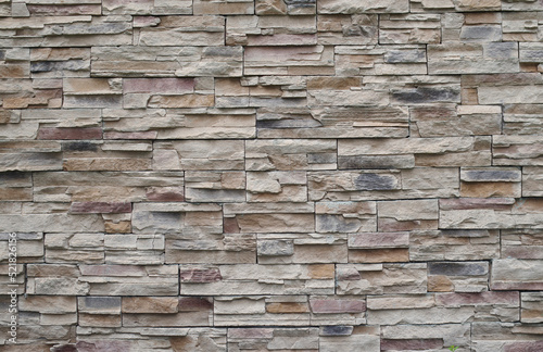Colorful relief tiles imitating stone on wall close
