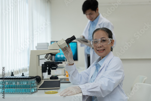 Portrait of Scientist with Microscope Does Analysis of Test Sample.