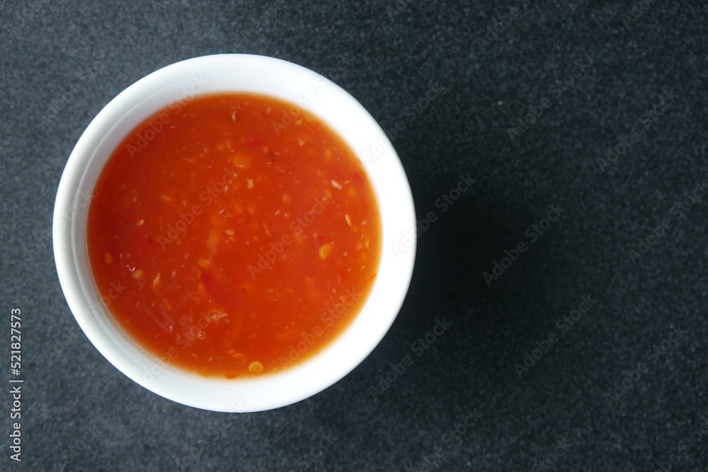 chili tomato sauce in a small jar on table chili tomato sauce in a small jar on table