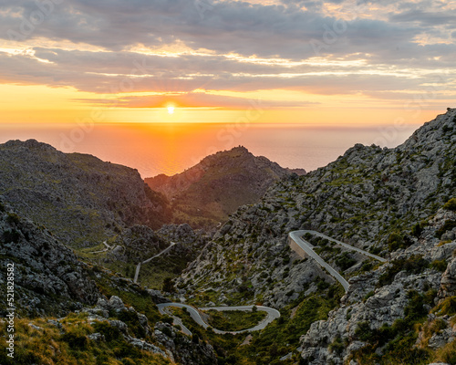 The Sa Calobra route, also known as the snake route is one of the most popular cycling routes of Mallorca.This picture is taken at sunset showing the sun dropping below the horizon. 