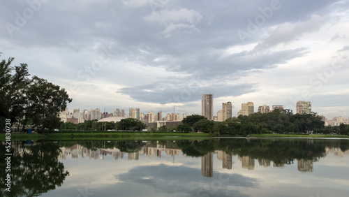 View of Ibirapuera Park, the first metropolitan park in São Paulo, Brazil, and one of the most visited parks in South America. In the background part of the city’s skyline reflected in a lagoon