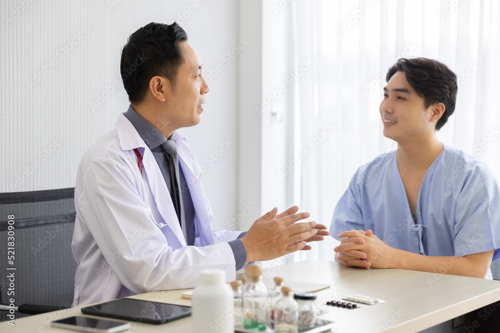 Professional doctor interacting consulting with young male patient at clinic, Male patient get advice about medicine from doctor at hospital Professional doctor interacting consulting with young male patient at clinic, Male patient get advice about medicine from doctor at hospital